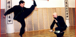 Raymond Lee (left) and John Hoppe performing "Single Saber vs. Empty Hand" weapon sparring form during the 16th Anniversary Party.