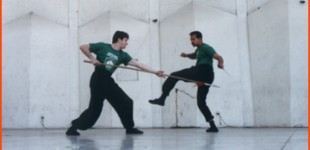 Jeffery Barcan (left) and Mark Muir performing "Double Daggers vs. Spear" weapons sparring form during a performance at Lincoln Center.